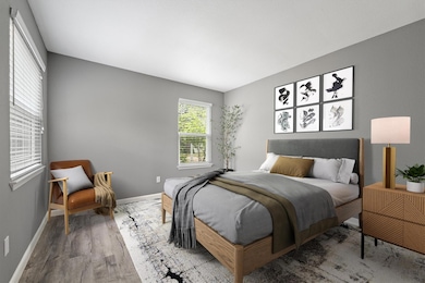 Bedroom featuring wood finished floors and basebo