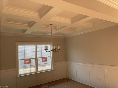 formal dining room with coffered ceiling