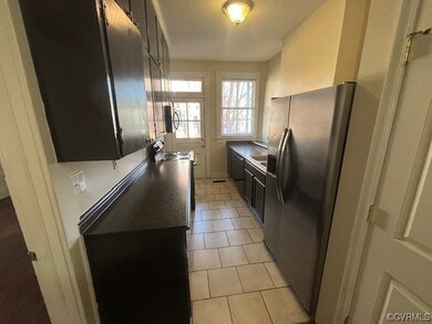 Kitchen with sink, stainless steel fridge, light t
