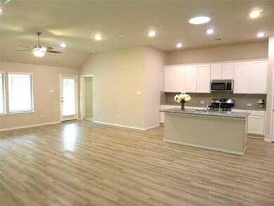 View of this nice kitchen with popular white cabinets,Granite counter and a big island.
