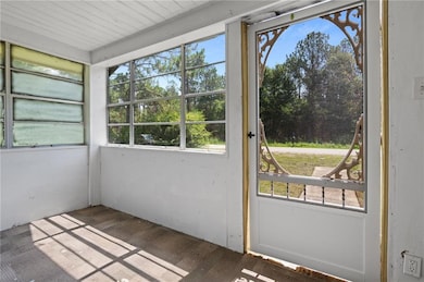 Unfurnished sunroom with healthy amount of natural light
