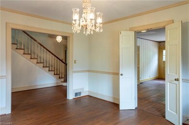 This view is from the formal dining room, peeking into the kitchen and foyer areas.