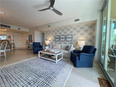 Living room with visible vents, wallpapered walls,