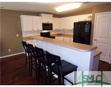 Kitchen. A breakfast bar adjoins the living area. 