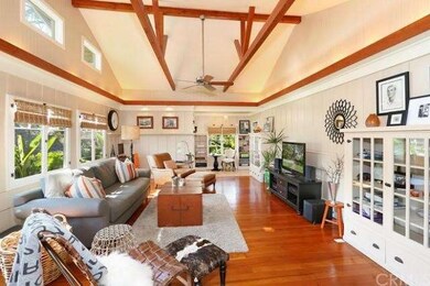 Living room with soaring truss beamed ceilings, pl