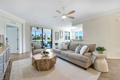 Living room featuring ceiling fan, ornamental molding, healthy amount of natural light, light tile patterned flooring, and baseboards