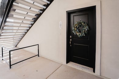 View of exterior entry featuring stucco siding