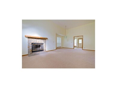 Spacious living room features fireplace, new carpe
