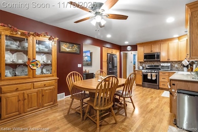Dining area with light wood-style floors, ceiling fan, and recessed lighting