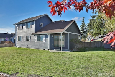A view looking at the back of the home from the golf course.