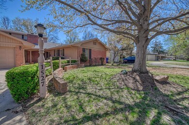 Front elevation with brick accents and wood posts