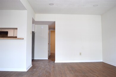 Spare room featuring baseboards, a textured ceili