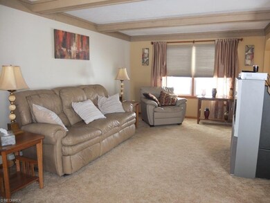 Great room with wood burner is open to the dining 