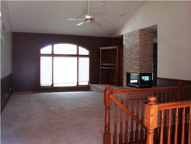 Living room offers vaulted ceiling, ceiling fan, c