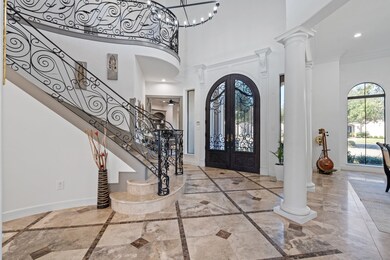 Grand entryway through the arched front door, with