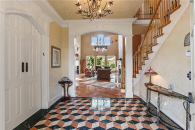 The stunning entry features custom geometric floor