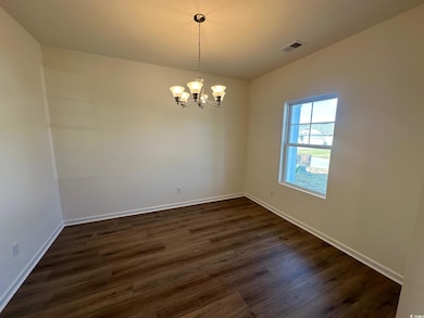 Empty room featuring dark hardwood / wood-style fl