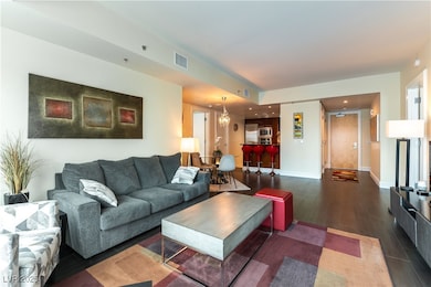 Living area featuring dark wood-style flooring, a