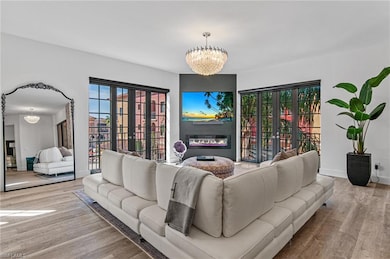 Living area featuring a notable chandelier, a glas