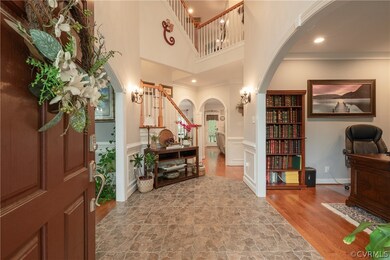 Front door opens to elegant, stone tiled entranceway