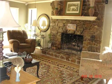 Family room with stone fireplace.  French door ope
