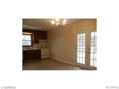 Kitchen with French door leading to large deck on the back