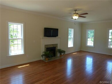 Living Room with Gas FP, Ceiling Fan & Hardwood Fl