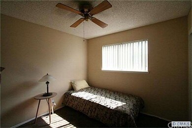 Very cute bedroom with ceiling fan.