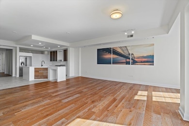 Unfurnished living room featuring baseboards, ligh