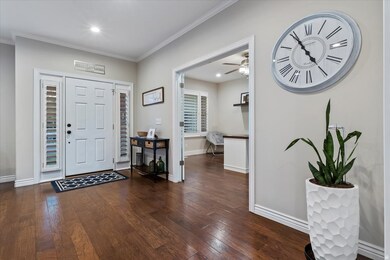 Foyer entrance featuring dark wood-style floors, crown molding, recessed lighting, and a ceiling fan
