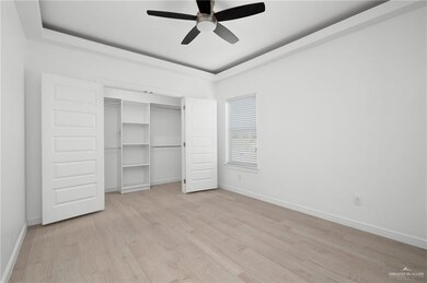 Unfurnished bedroom featuring a closet, light hardwood / wood-style floors, and ceiling fan