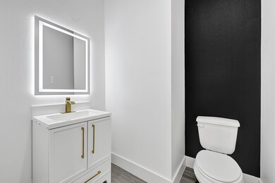 Stylish half bath with floating vanity, gold fixtu