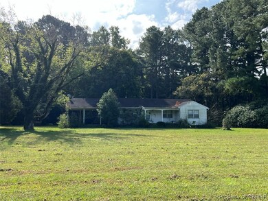 Single story home featuring a front lawn