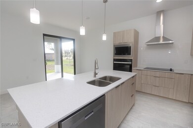 Kitchen with wall chimney exhaust hood, light brow