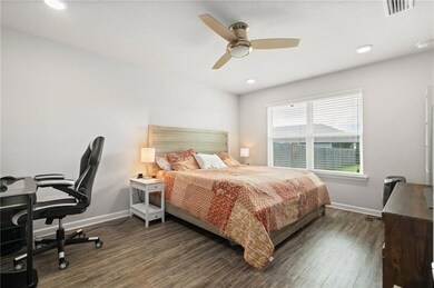 Bedroom with wood finished floors, baseboards, a desk, ceiling fan, and recessed lighting