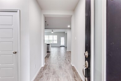 Hallway with baseboards and light wood-type floor