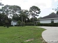View Of Left Side Of Home With Custom Built Outdoo