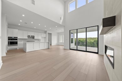 Unfurnished living room featuring a towering ceil