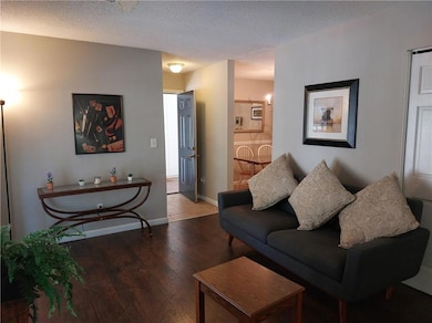 Living room featuring wood finished floors, a text