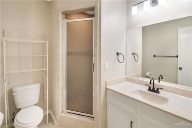 Bathroom with vanity, a stall shower, and tile patterned flooring