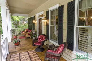 A welcoming front porch adorns the entryway overlo