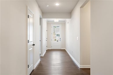 Hallway featuring dark hardwood / wood-style floor