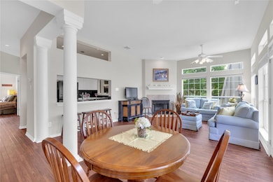 Dining area with a ceiling fan, a tile fireplace,