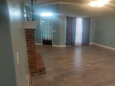 Corridor with tile patterned flooring, crown molding, and baseboards