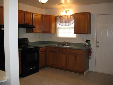 The kitchen is lovely with updated cabinetry and recently new appliances! Door leads to the back yard!