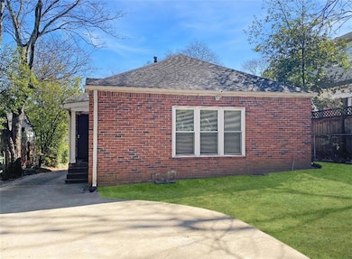 View of home's exterior with a yard, brick siding,