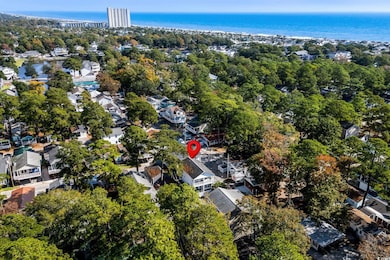 Aerial view of property's location with nearby suburban area