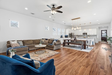 Living room with light wood finished floors, rece