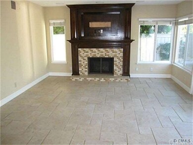 Vacant Family Room with Fireplace Opens to Kitchen