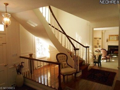 Stately foyer with dramatic staircase.